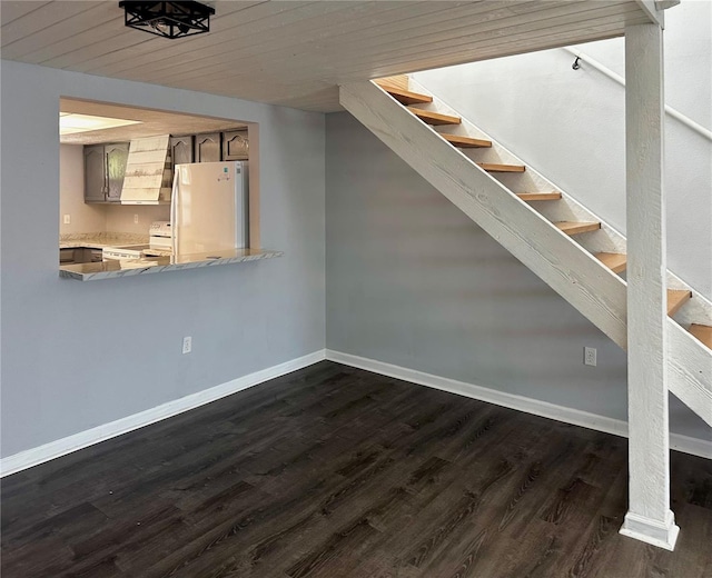 interior space with white refrigerator, dark hardwood / wood-style floors, and wood ceiling