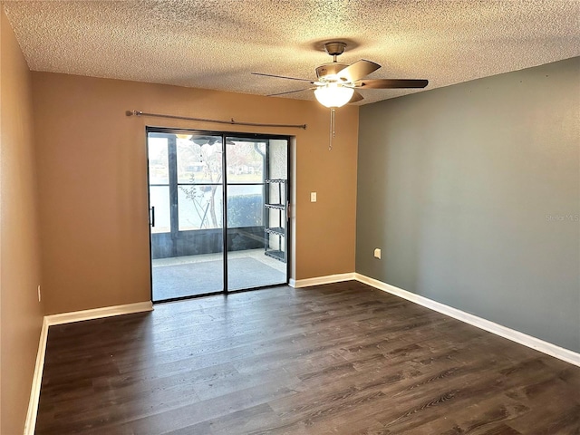 spare room with ceiling fan, dark hardwood / wood-style flooring, and a textured ceiling