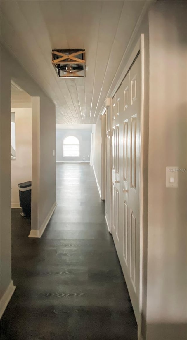 9107 Lingrove Rd, Weeki Wachee, FL 34613 - hall with baseboards and dark wood-style flooring