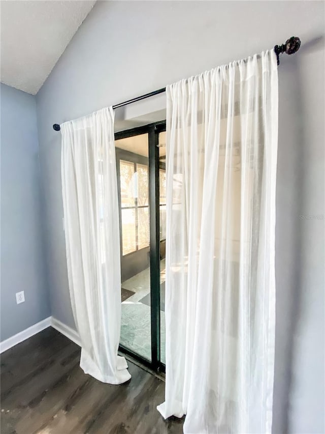 9107 Lingrove Rd, Weeki Wachee, FL 34613 - interior space with vaulted ceiling, wood finished floors, and baseboards