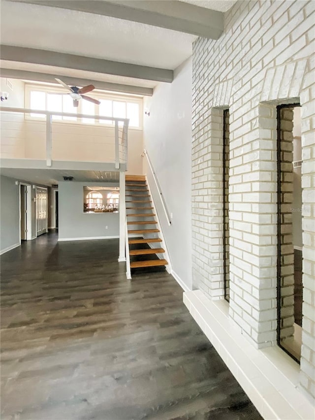 9107 Lingrove Rd, Weeki Wachee, FL 34613 - staircase with beam ceiling, baseboards, and wood finished floors
