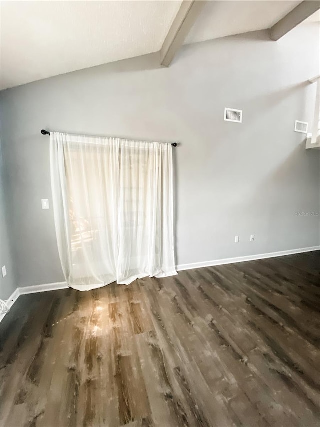 9107 Lingrove Rd, Weeki Wachee, FL 34613 - unfurnished room featuring baseboards, visible vents, vaulted ceiling with beams, and wood finished floors