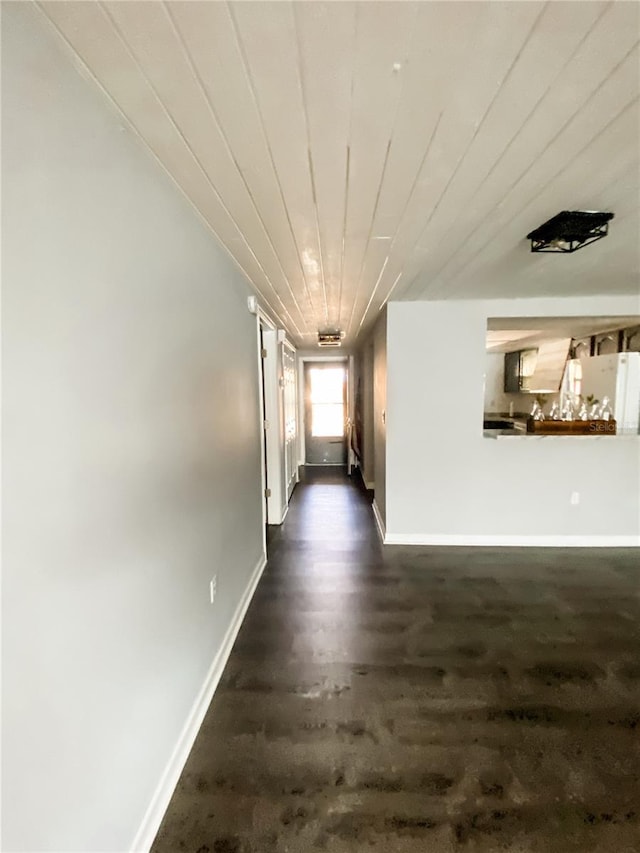 9107 Lingrove Rd, Weeki Wachee, FL 34613 - hall with baseboards and dark wood-style floors