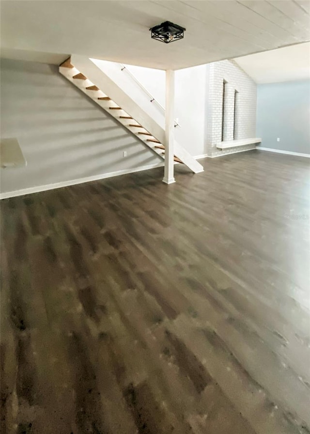 9107 Lingrove Rd, Weeki Wachee, FL 34613 - basement with baseboards, wood finished floors, and stairs