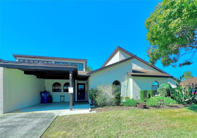 9107 Lingrove Rd, Weeki Wachee, FL 34613 - single story home featuring a front lawn, driveway, a carport, and stucco siding