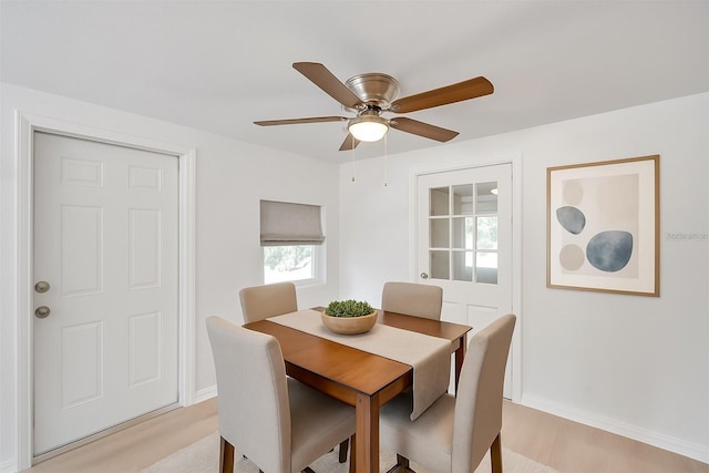 dining area featuring light wood-style flooring and a ceiling fan