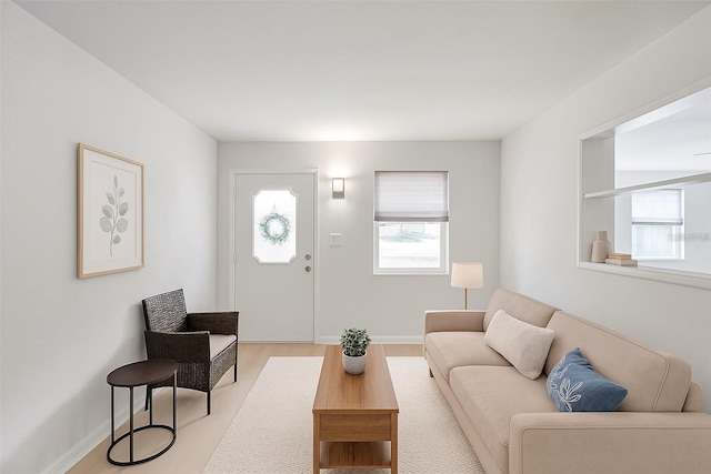 living room with baseboards and light wood-style floors