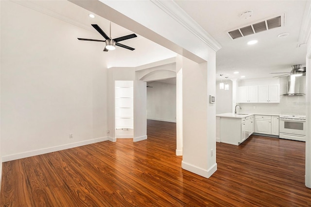 unfurnished living room featuring ornamental molding, ceiling fan, dark wood-type flooring, and sink