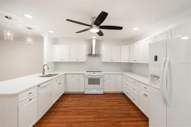 kitchen with sink, wall chimney range hood, dark hardwood / wood-style flooring, kitchen peninsula, and white appliances