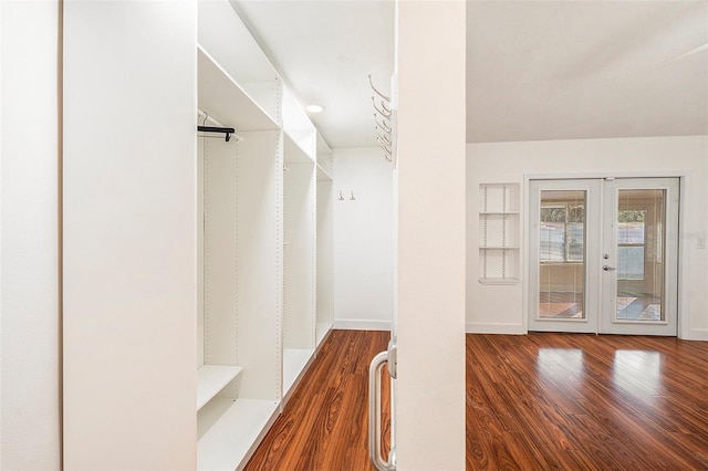 spacious closet featuring hardwood / wood-style floors and french doors