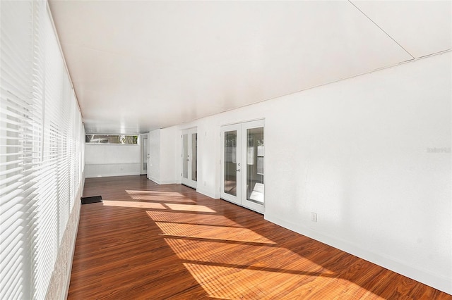 spare room featuring french doors and hardwood / wood-style floors