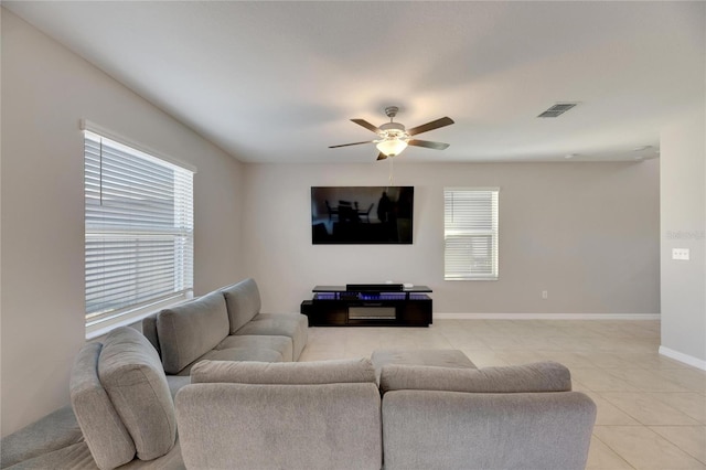 living room with ceiling fan and light tile patterned floors