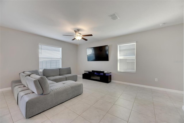 living room featuring ceiling fan and light tile patterned flooring