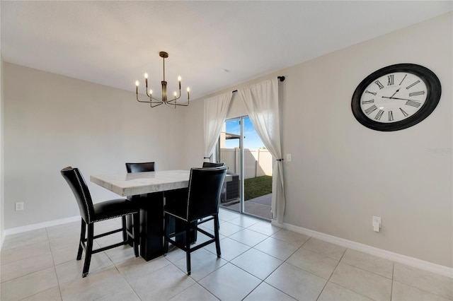 dining room with light tile patterned flooring and a notable chandelier