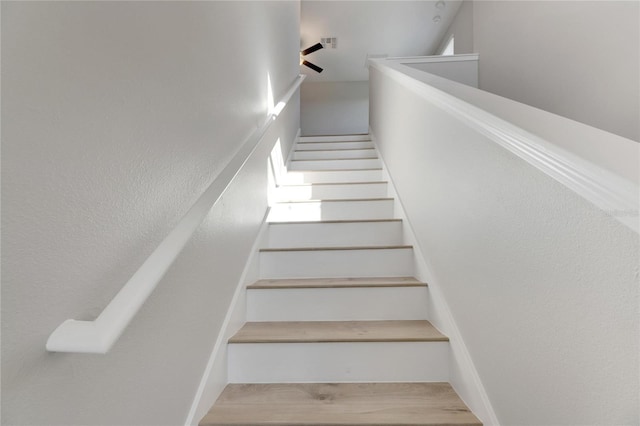 stairs with wood-type flooring