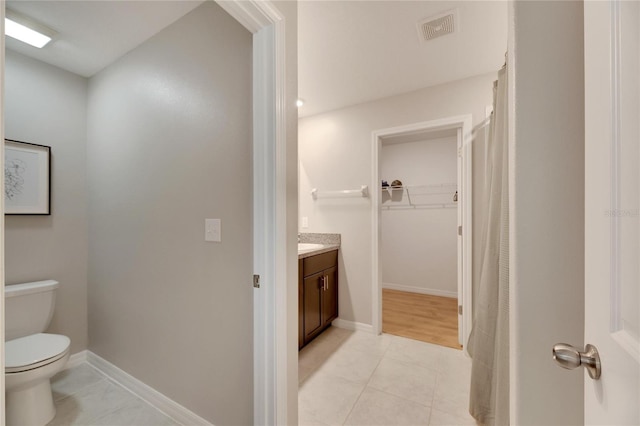 bathroom with tile patterned floors, vanity, and toilet