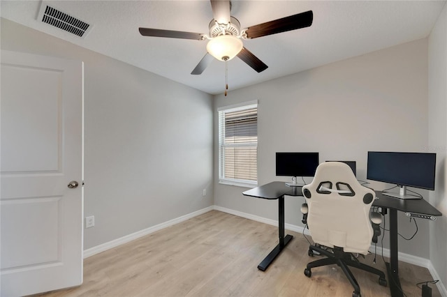 office with ceiling fan and light hardwood / wood-style flooring