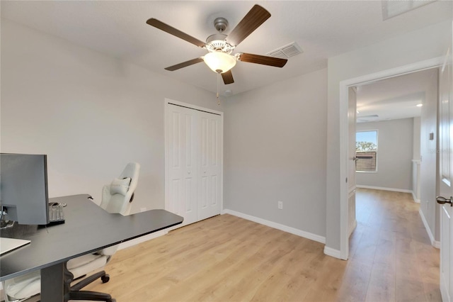 office with ceiling fan and light hardwood / wood-style flooring