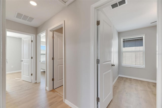 corridor with light wood-type flooring