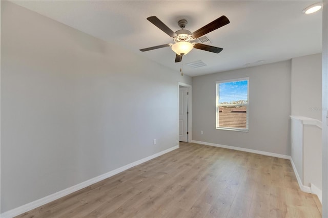 spare room with ceiling fan and light wood-type flooring