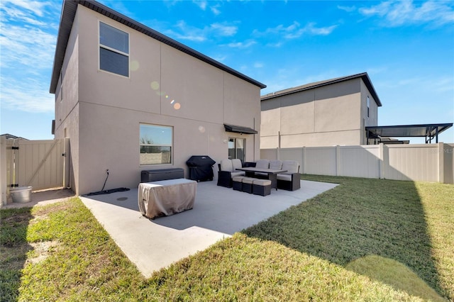 back of house with a lawn, an outdoor living space, and a patio