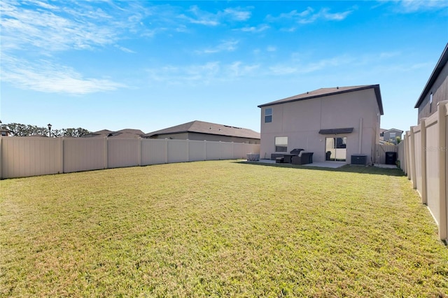 view of yard featuring central AC and a patio