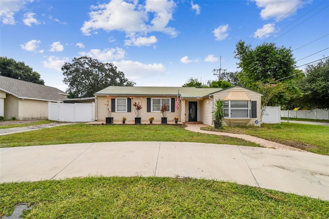 ranch-style home featuring central AC and a front lawn