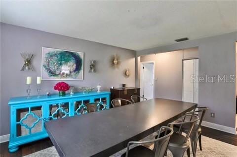 dining area featuring dark wood-type flooring