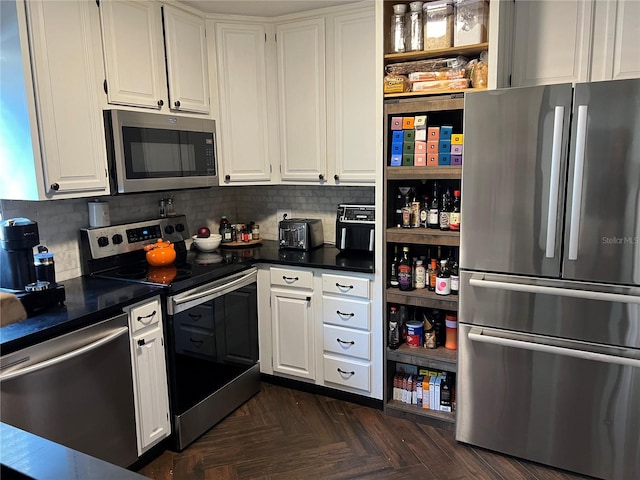 kitchen featuring tasteful backsplash, dark parquet floors, white cabinets, and stainless steel appliances