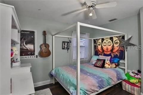 bedroom featuring ceiling fan and dark wood-type flooring