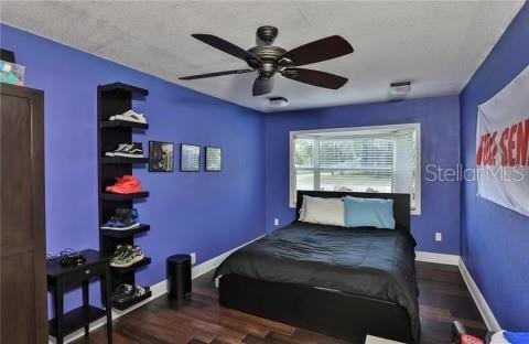 bedroom featuring ceiling fan and dark hardwood / wood-style flooring