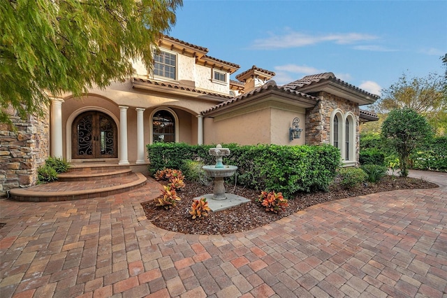 mediterranean / spanish-style home with french doors