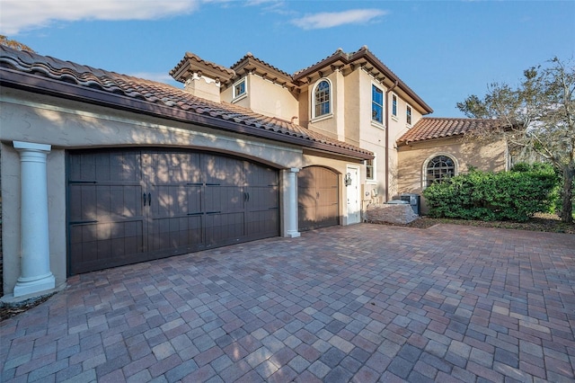 mediterranean / spanish house featuring a garage