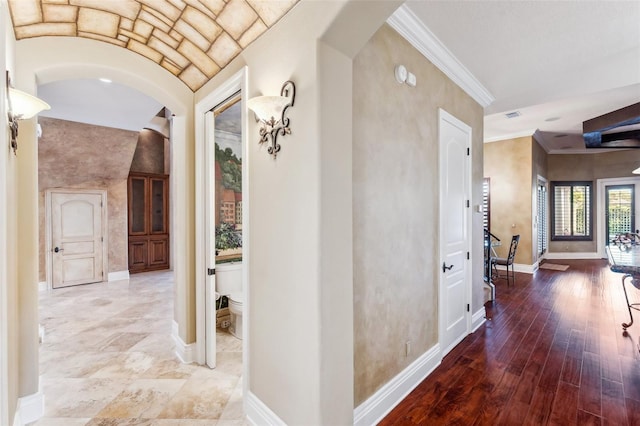 hall with hardwood / wood-style flooring and crown molding