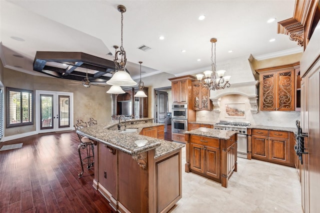 kitchen featuring hanging light fixtures, kitchen peninsula, a breakfast bar area, appliances with stainless steel finishes, and light wood-type flooring