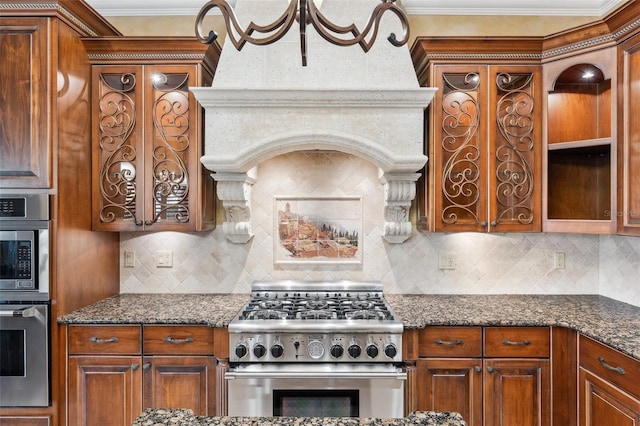 kitchen with decorative backsplash, stainless steel appliances, and dark stone counters