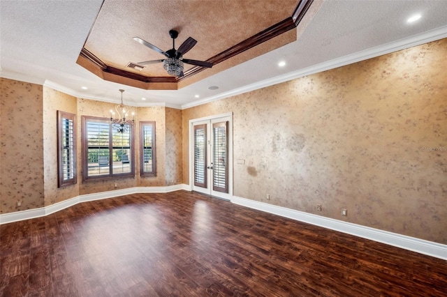 unfurnished room with a tray ceiling, crown molding, and wood-type flooring