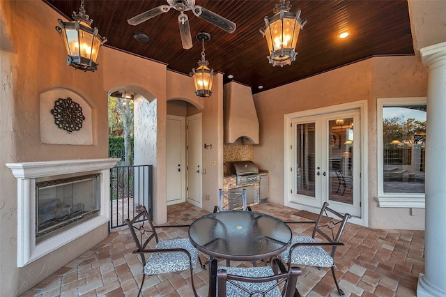 view of patio / terrace featuring french doors, grilling area, exterior kitchen, and ceiling fan