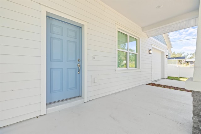 view of exterior entry with a garage