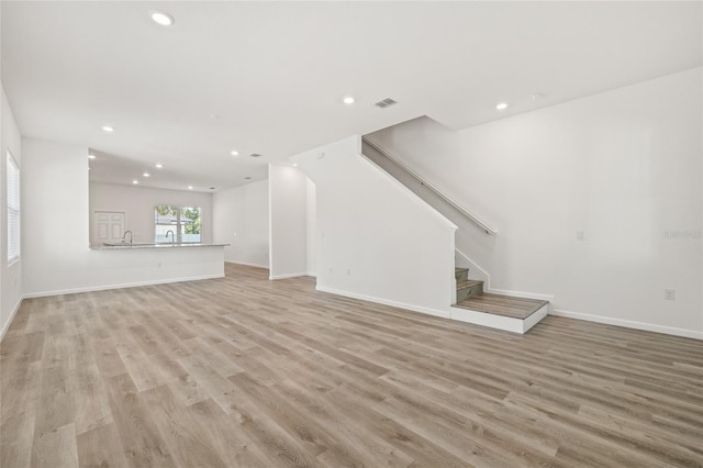 unfurnished living room with light hardwood / wood-style flooring