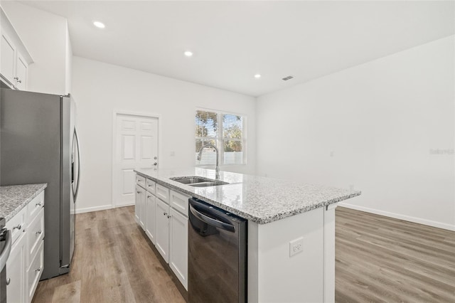 kitchen with a center island with sink, sink, light hardwood / wood-style flooring, white cabinetry, and stainless steel appliances