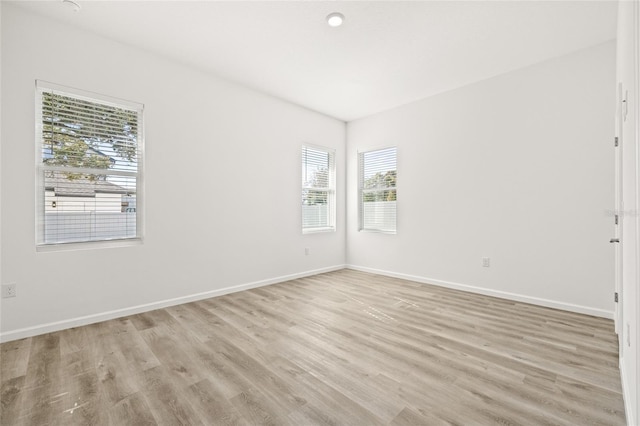 empty room featuring light hardwood / wood-style flooring and a healthy amount of sunlight