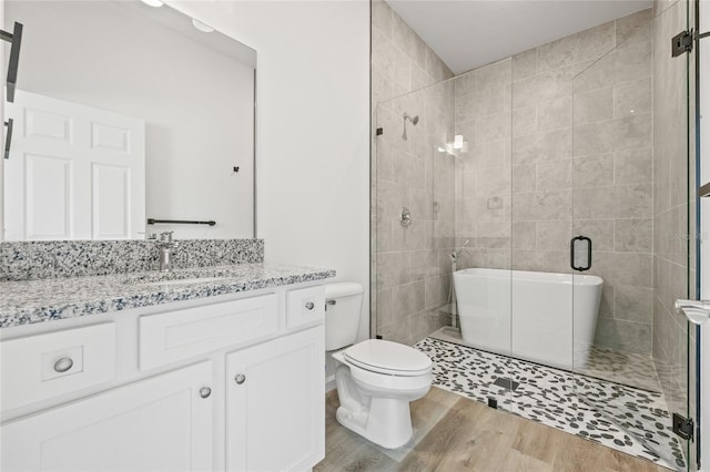 full bathroom with plus walk in shower, toilet, vanity, and hardwood / wood-style flooring