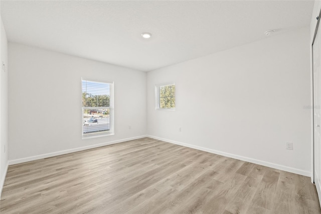 unfurnished room featuring light hardwood / wood-style flooring