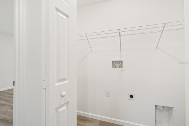 clothes washing area with washer hookup, electric dryer hookup, and wood-type flooring