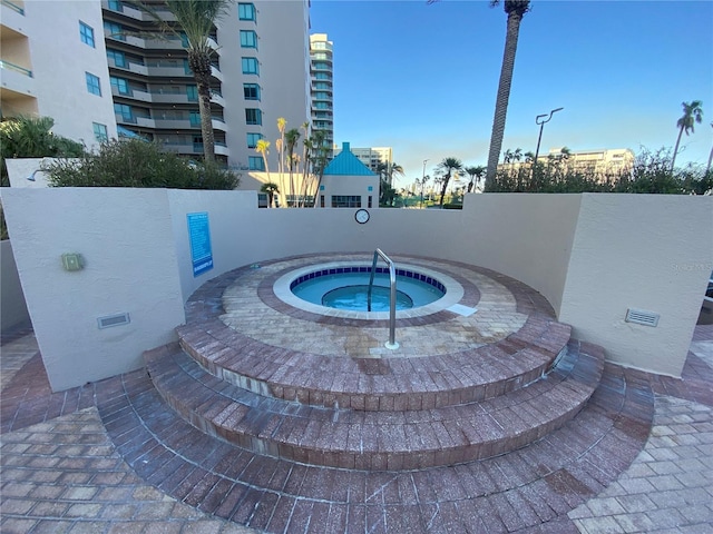 view of swimming pool featuring a hot tub