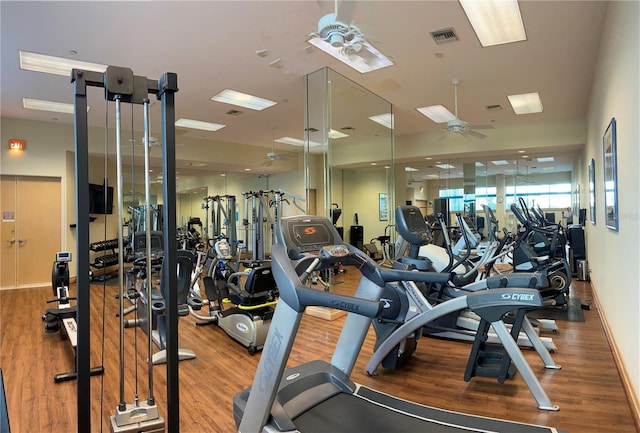 exercise room with hardwood / wood-style floors and ceiling fan