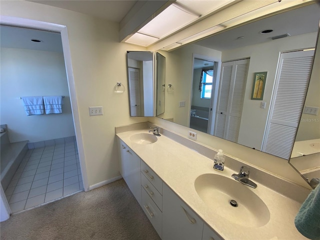 bathroom featuring tile patterned flooring and vanity