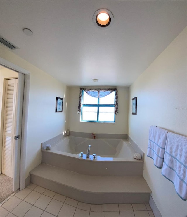 bathroom featuring a bathing tub and tile patterned flooring