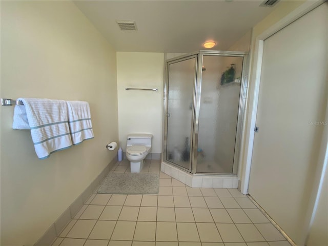 bathroom featuring toilet, tile patterned floors, and walk in shower